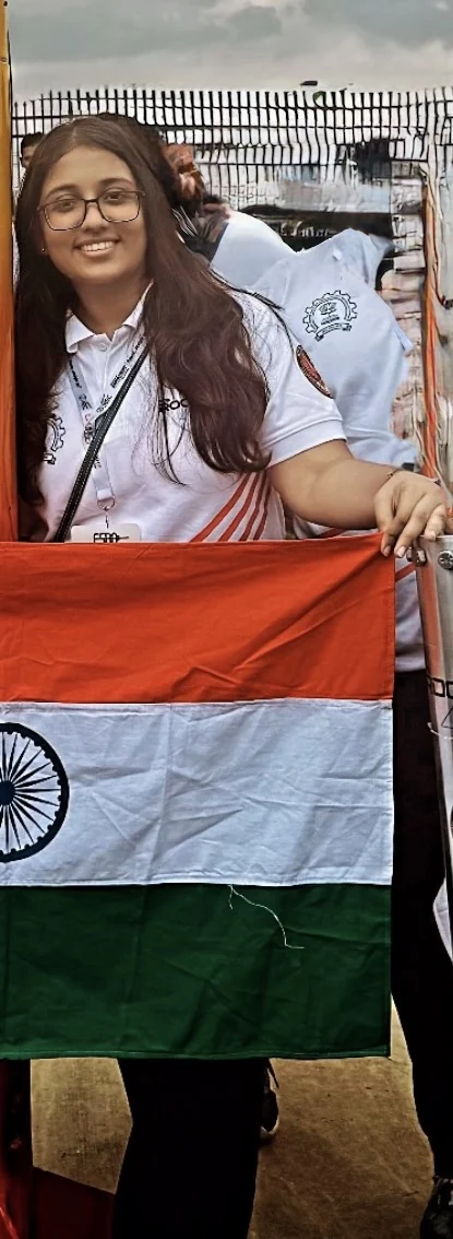 Captain smiling while holding the Indian flag