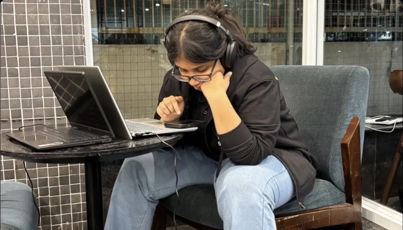 Captain studying with headphones and a laptop